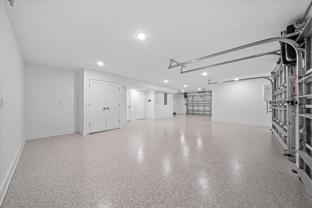 garage featuring baseboards and recessed lighting