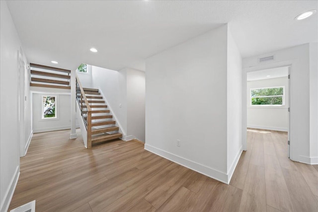 interior space featuring recessed lighting, baseboards, visible vents, and wood finished floors