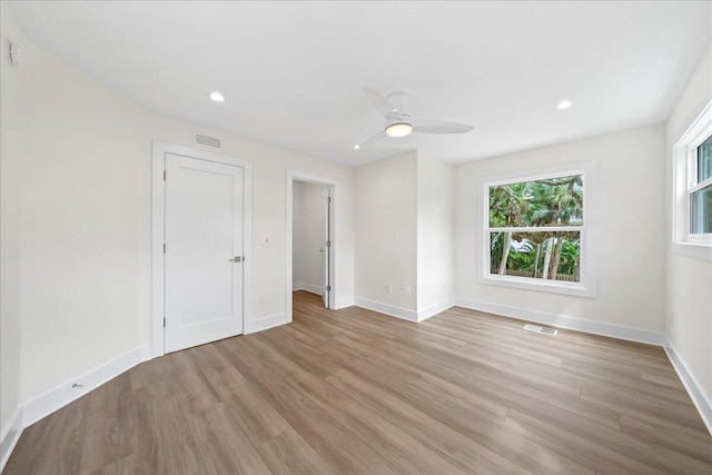 spare room with recessed lighting, baseboards, light wood-type flooring, and visible vents