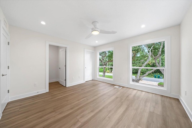 interior space with ceiling fan, recessed lighting, baseboards, light wood-type flooring, and visible vents