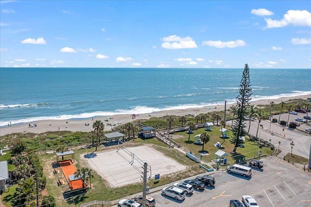 bird's eye view with a water view and a beach view