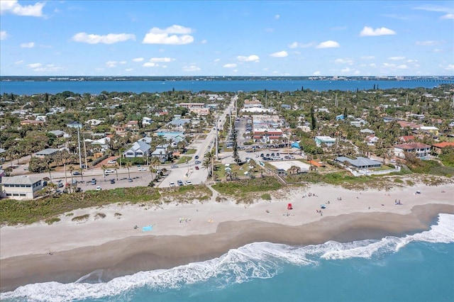 bird's eye view featuring a water view and a beach view