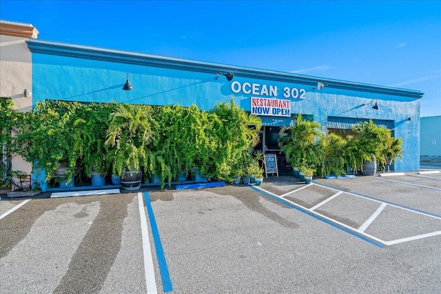 view of building exterior with uncovered parking