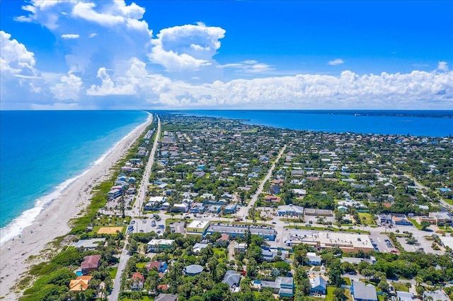 drone / aerial view with a beach view and a water view