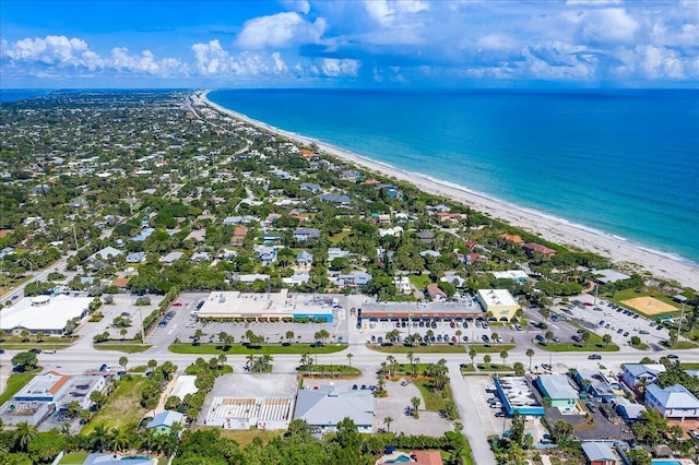 birds eye view of property featuring a water view and a beach view