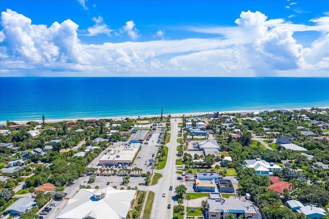 bird's eye view featuring a water view, a beach view, and a residential view