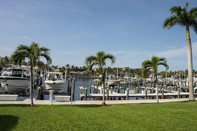 dock area with a yard, a water view, and boat lift