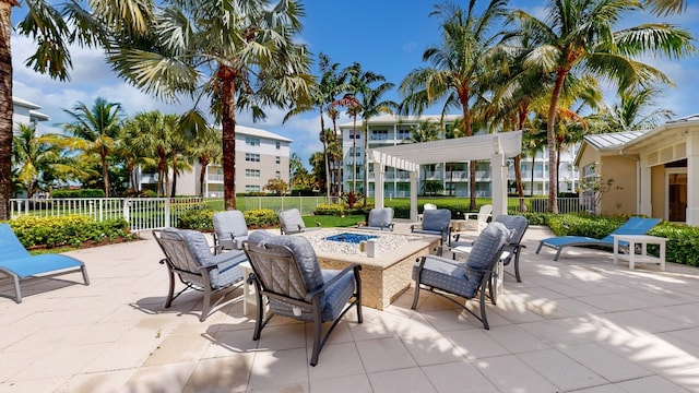 view of patio / terrace with a fire pit and fence