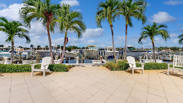 view of patio featuring boat lift and a dock