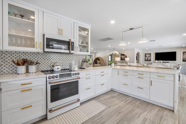 kitchen with appliances with stainless steel finishes, light wood-type flooring, and white cabinetry