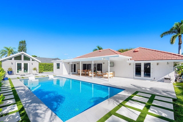 view of pool featuring a patio and french doors