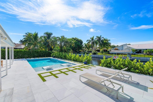 view of swimming pool with a patio and a water view