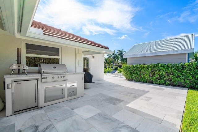 view of patio / terrace with an outdoor kitchen and grilling area