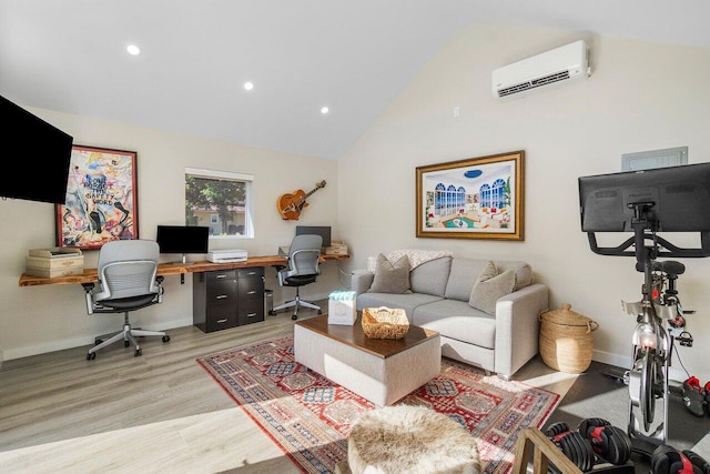 office area featuring light hardwood / wood-style floors, high vaulted ceiling, and a wall mounted air conditioner