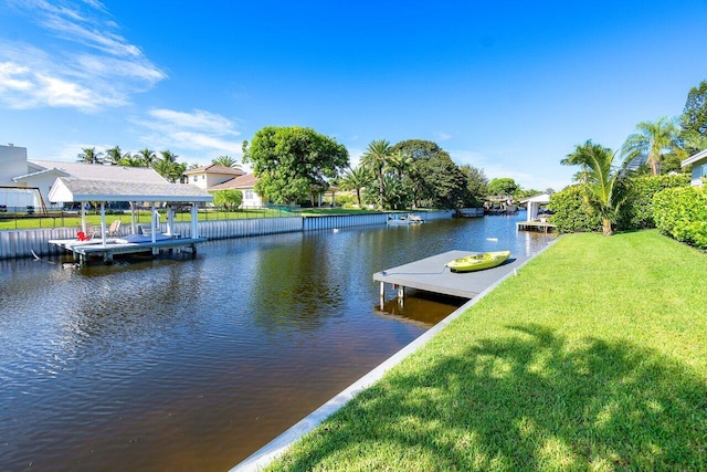 dock area featuring a water view and a lawn