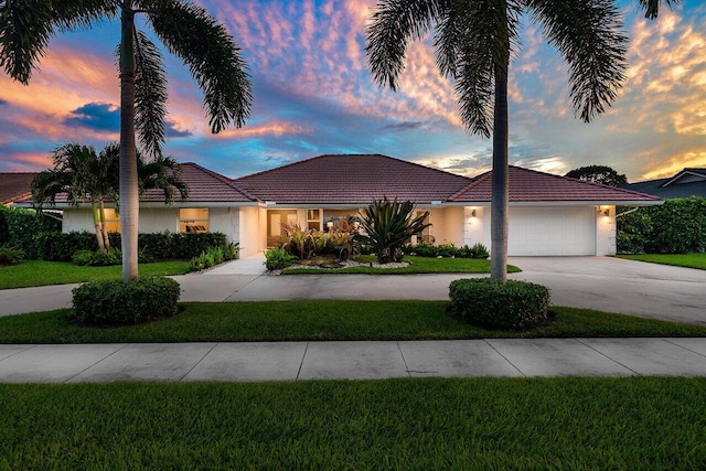 view of front facade with a lawn and a garage