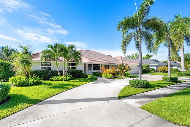 view of front of home with a front yard and a garage