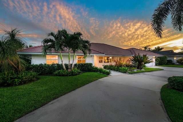 single story home with a lawn and a garage