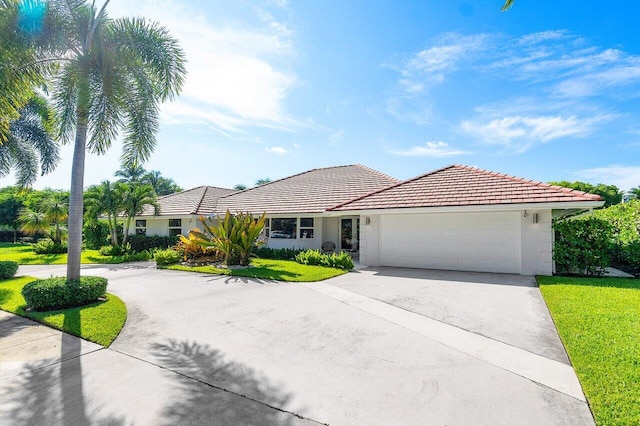 view of front of house with a front lawn and a garage