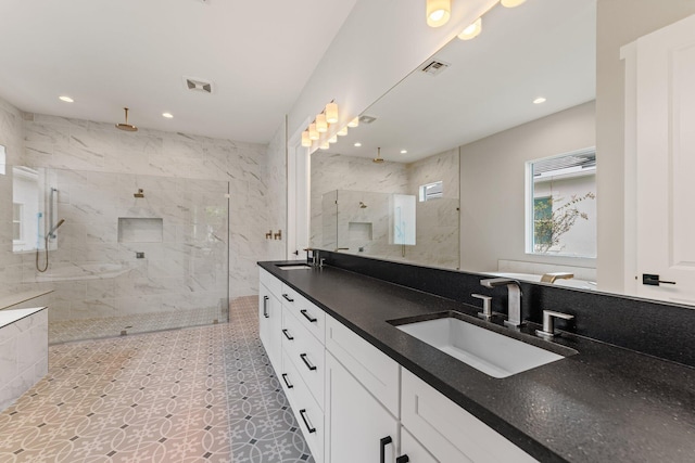 bathroom featuring vanity and tiled shower