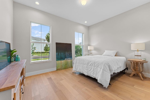 bedroom featuring light hardwood / wood-style floors and multiple windows