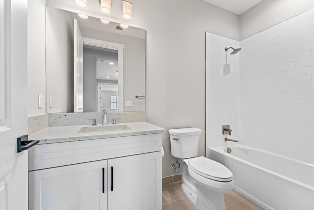 full bathroom with toilet, tiled shower / bath, vanity, and tile patterned flooring