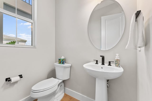 bathroom with wood-type flooring and toilet