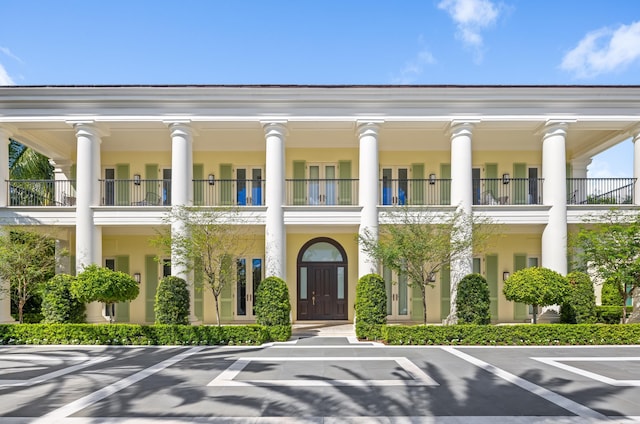 greek revival inspired property featuring a balcony