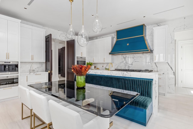 kitchen featuring a kitchen island, custom range hood, and white cabinets