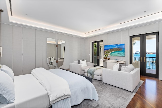 bedroom featuring hardwood / wood-style floors, access to exterior, multiple windows, and french doors