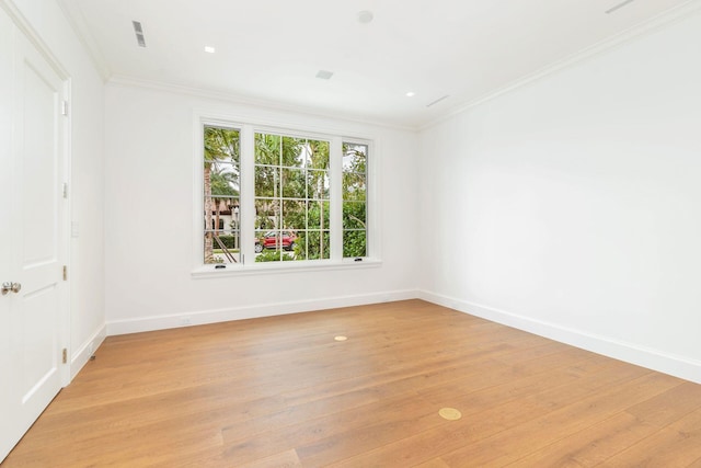 unfurnished room with light wood-type flooring and ornamental molding