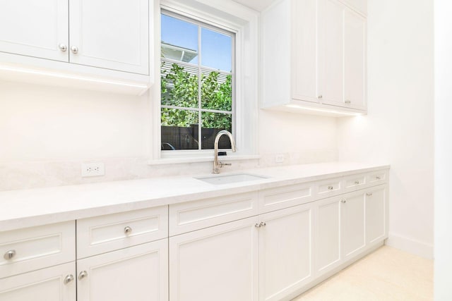 kitchen featuring sink and white cabinets