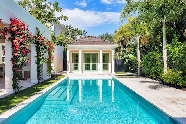 view of swimming pool with an outbuilding