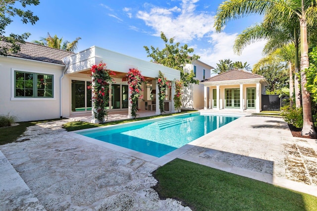 view of pool with an outdoor structure and a patio area