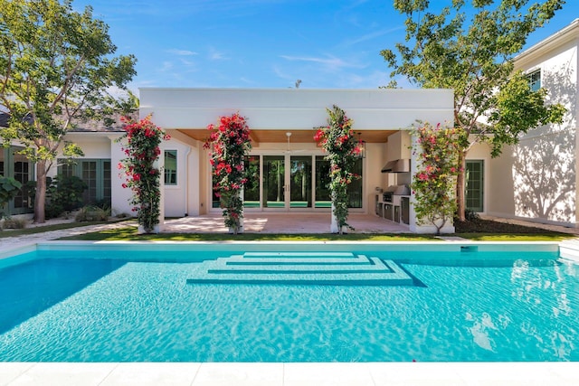 view of pool featuring a patio and exterior kitchen