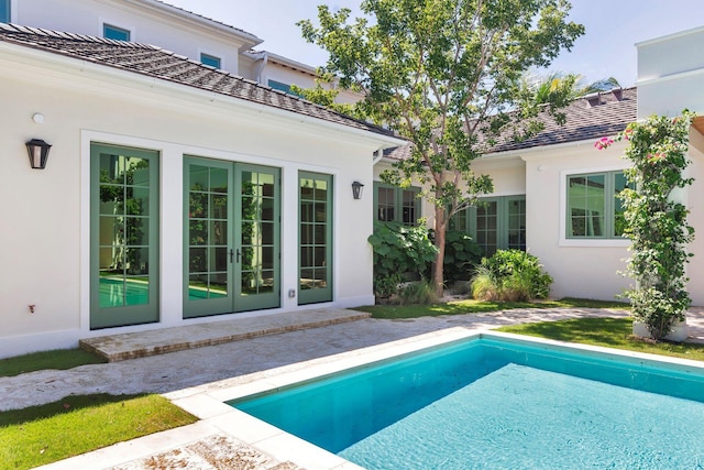 view of swimming pool with a patio and french doors