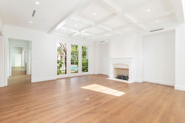 unfurnished living room featuring a fireplace, french doors, light wood-type flooring, coffered ceiling, and beam ceiling