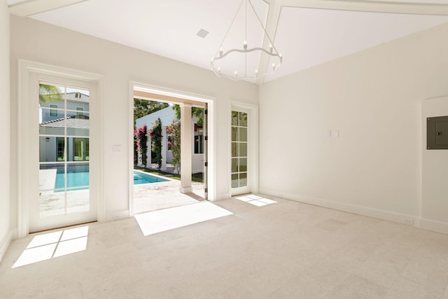 interior space with electric panel and a chandelier