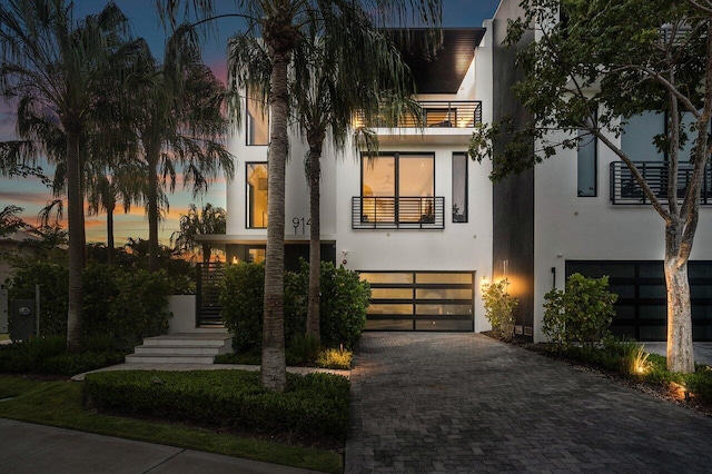 view of front facade featuring a garage and a balcony