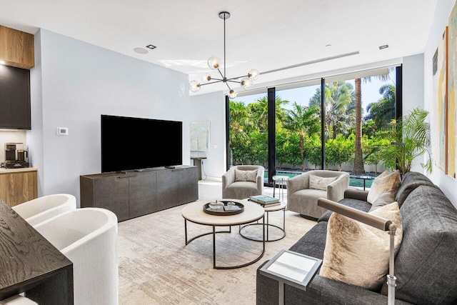 living room featuring a wealth of natural light, expansive windows, and a notable chandelier