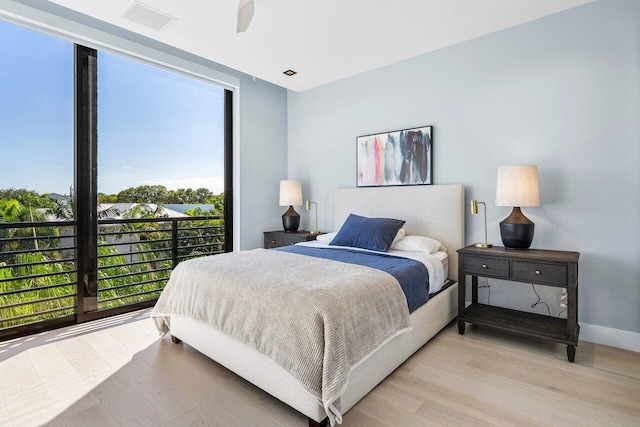 bedroom with light hardwood / wood-style flooring and ceiling fan