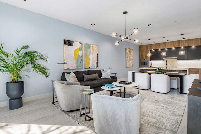 living room with a notable chandelier and sink