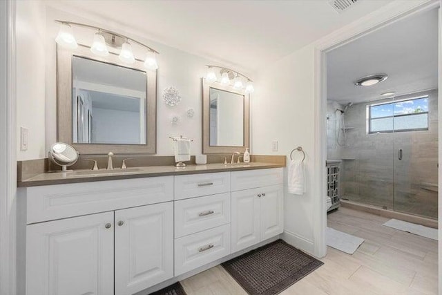 bathroom with a shower with door and vanity