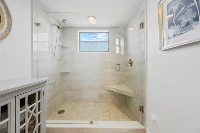 bathroom with a shower with door