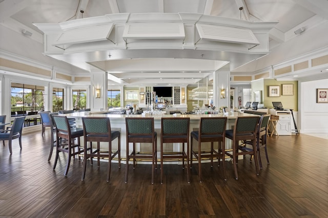 kitchen featuring dark hardwood / wood-style floors, a wealth of natural light, and a kitchen bar