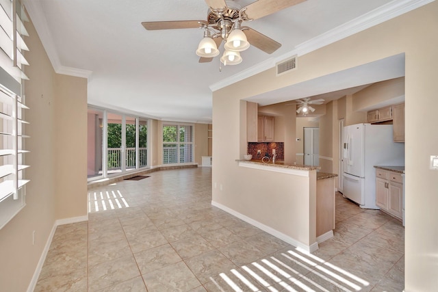 kitchen with decorative backsplash, white refrigerator, crown molding, and ceiling fan