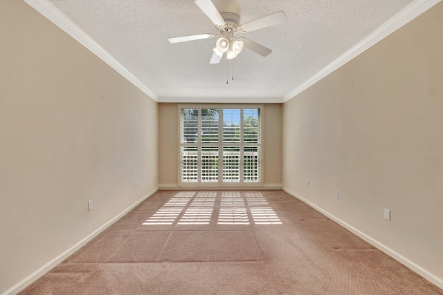 carpeted empty room with ceiling fan, ornamental molding, and a textured ceiling