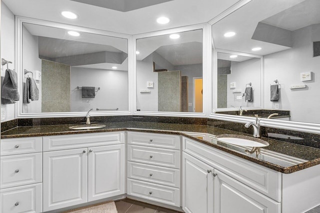 bathroom with tile patterned floors, vanity, and a shower