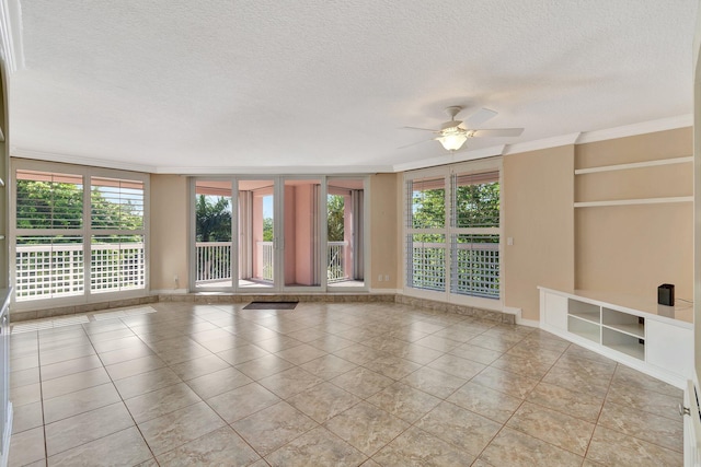 empty room featuring light tile patterned floors, a textured ceiling, ceiling fan, and ornamental molding