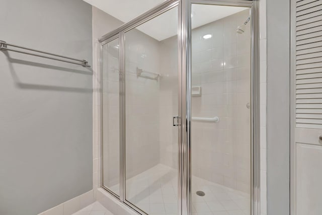 bathroom with tile patterned flooring and walk in shower